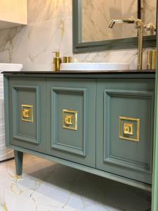 a bathroom with a blue cabinet with a sink at Vert Unique Luxury Experience in Băile Felix in Baile Felix +124 photos