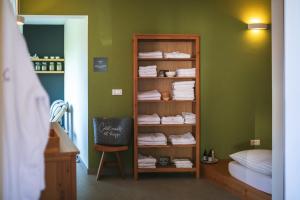 a room with a book shelf filled with towels at Lill' Hill estate & wellness - Anna Apartment in Idrija +69 photos
