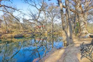 a bench next to a body of water at Dew Drop Inn in Wimberley