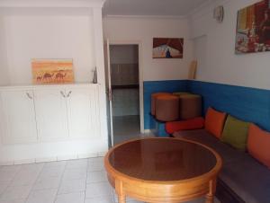 a living room with a table and a couch at amazigh soul experience in Mirleft
