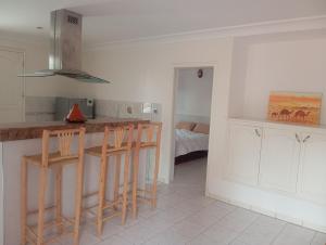 a kitchen with a counter and stools in a room at amazigh soul experience in Mirleft