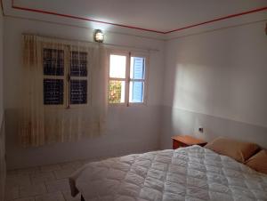 a bedroom with a large bed and a window at amazigh soul experience in Mirleft