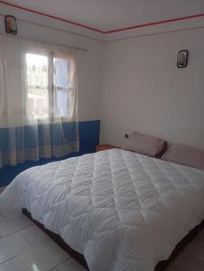 a white bed in a bedroom with a window at amazigh soul experience in Mirleft +32 photos