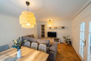 a living room with a couch and a table at Villa Si y No in Gijón