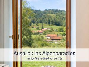 a window with a view of a village at Alpenstudio Sachrang - Terrasse & Bergblick - Ruhe & Natur pur in Aschau im Chiemgau