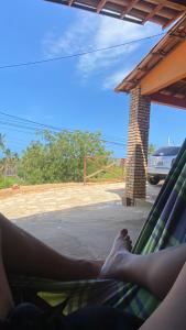 a person laying in a hammock looking out at at Casaacochego in Icapuí +7 photos
