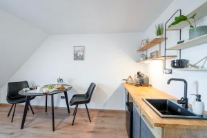 a kitchen with a table and chairs and a sink at Studio Arnoštka in Vimperk +23 photos