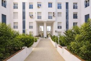 a building with a walkway in front of it at Captivating 2-Bed Apartment in Tunis in Tunis