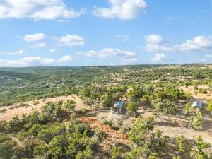 an aerial view of a house on a hill with trees at Daybreak Ridge Sunrise Bluff in Blanco