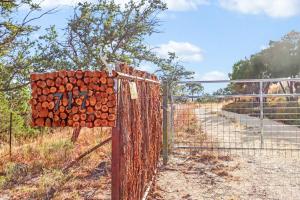 a fence with a sign on it next to a road at Daybreak Ridge Sunrise Bluff in Blanco
