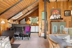 a living room with a dining room and a kitchen at 2614-Romo-Stormengevej-18 in Høm