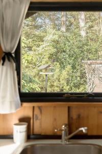 a window over a sink with a view of trees at 2614-Romo-Stormengevej-18 in Høm +19 photos