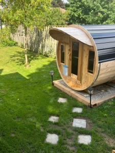 a small wooden house sitting in the grass at Walkerton Sauna Suite in Walkerton