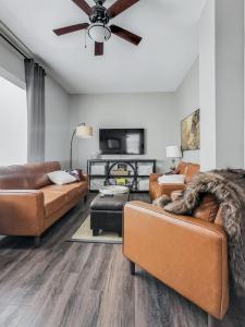 a living room with couches and a ceiling fan at Walkerton Sauna Suite in Walkerton +22 photos