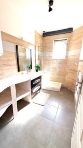 a bathroom with a large sink and a tub at La Halte Montbrisonnaise in Montbrison +28 photos