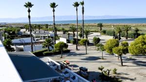 an aerial view of a resort with palm trees and the ocean at Le Dune del Gargano in Zapponeta