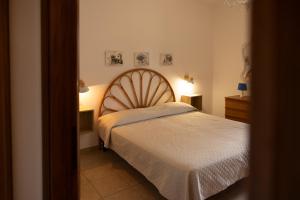 a bedroom with a bed and two night stands at Padulella Mare - HelloElba in Portoferraio