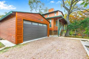 a house with a garage door in front of it at Cypress Star in Wimberley