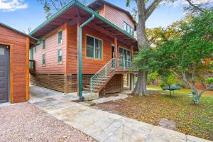 a house with a staircase in front of a tree at Cypress Star in Wimberley +34 photos
