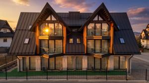 a house with a black roof at CHATAR Tatra Premium Suites in Zakopane +142 photos