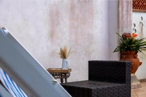 a room with a chair and a table with flowers at Padulella Mare - HelloElba in Portoferraio