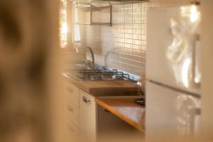 a kitchen with a sink and a stove at Padulella Mare - HelloElba in Portoferraio +71 photos
