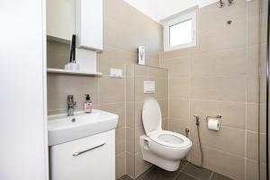 a bathroom with a toilet and a sink at Sarajevo Boutique Studios in Sarajevo