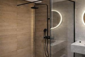 a shower with a glass door in a bathroom at Captivating 2-Bed Apartment in Tunis in Tunis +47 photos