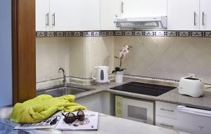 a kitchen with a sink and a towel and glasses at Luna Clube Oceano in Albufeira +47 photos