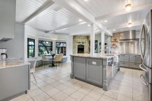 a kitchen with an island in the middle of a room at D2 Farms Main House in Wimberley +13 photos