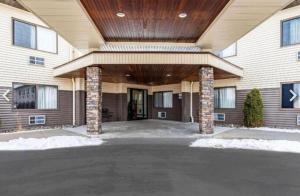 a large building with a porch with a roof at Budget Inn in Ithaca