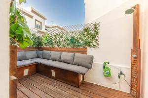 a couch on a deck with a fence at Apartamento Las Gaviotas 9A in Tarifa