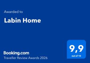 a blue screen with the text awarded to laundry home at Labin Home in Labin +9 photos