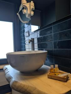 a bathroom with a bowl sink on a wooden counter at La Sosta del Cardinale in Montefiascone +43 photos