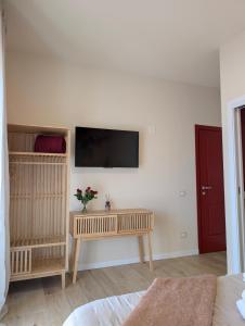 a living room with a flat screen tv on a wall at La Sosta del Cardinale in Montefiascone