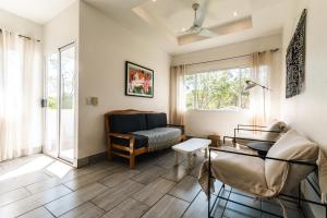 a living room with a couch and a table at Pazifico Villas in Playa Avellana