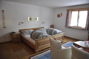 a bedroom with a bed with two pillows on it at Chesa Viletta in La Punt-Chamues-ch