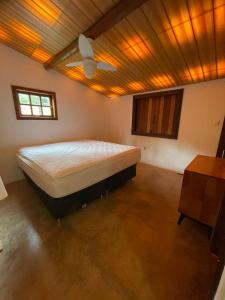 a bedroom with a large bed in a room at Sítio Funilândia - MG in Funilândia +23 photos