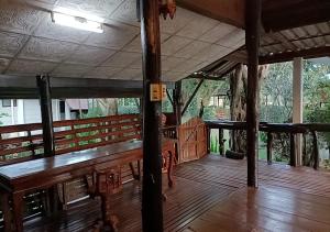 a wooden porch with benches on a wooden deck at LUCKY PAI Resort&Hostel in Pai