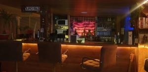 a bar with chairs in front of a bar at Zimmer mit Doppelbett in Zagreb