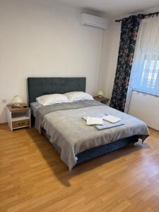 a bedroom with a bed with two towels on it at Kuća za odmor Nikola Medjugorje in Čitluk
