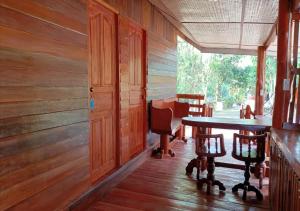 a room with a table and chairs in a cabin at LUCKY PAI Resort&Hostel in Pai +49 photos