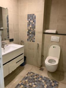a bathroom with a toilet and a sink at MZK Apartment in Islamabad