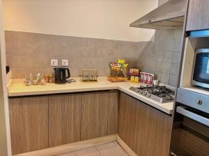 a kitchen with a stove and a counter top at MZK Apartment in Islamabad +1 photo