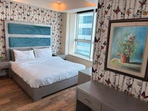 a bedroom with a bed and a window at MZK Apartment in Islamabad