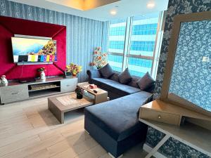 a living room with a couch and a tv at MZK Apartment in Islamabad