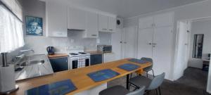 a kitchen with a table and chairs in a room at Fantastic Two Bedroom Unit in Whakatane +22 photos