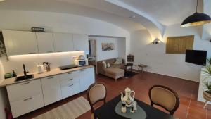 a kitchen and living room with a table and chairs at Apartment Mauthen 19 in Mauthen