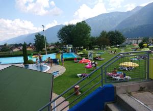 a group of people at a park with a pool at Apartment Mauthen 19 in Mauthen
