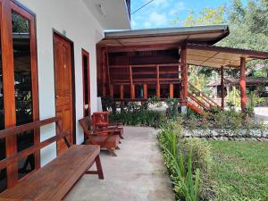 a group of benches sitting on a patio at LUCKY PAI Resort&Hostel in Pai